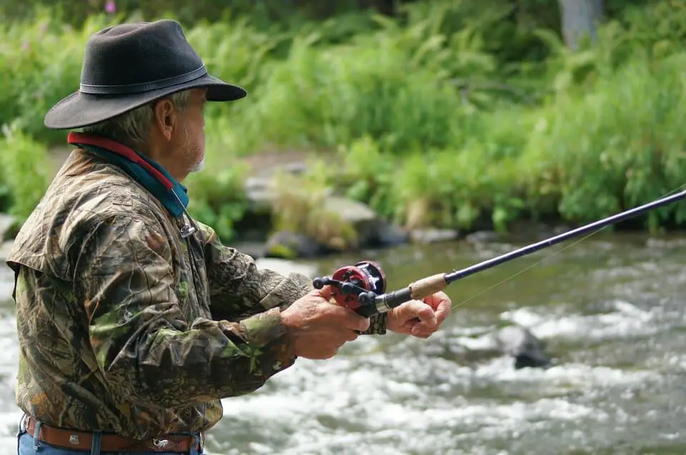 old fly fisherman fly fishing