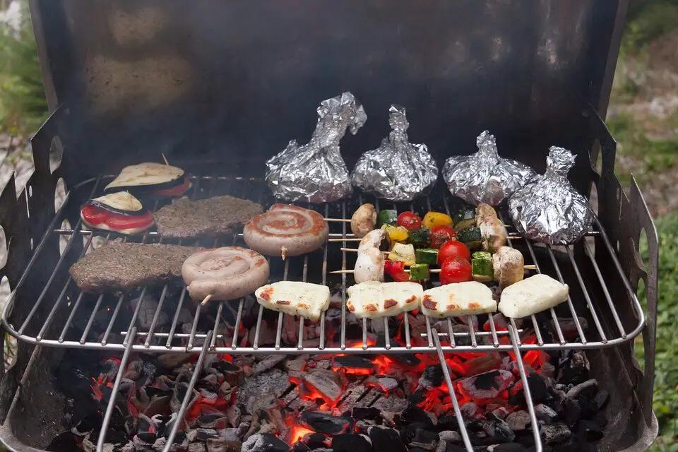 large food spread over charcoal grill