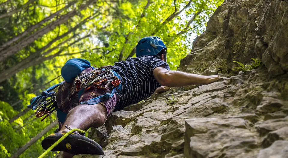 Man rock climbing cliff outside